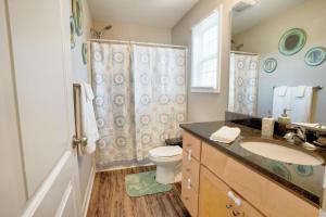 a bathroom with a sink and a toilet and a shower at Kannapolis Elegant Townhouse - Pet Friendly in Kannapolis +54 photos