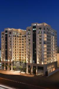a large apartment building at night with lights at Le Mirage Downtown in Doha