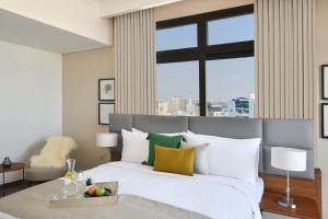 เตียงในห้องที่ Le Mirage Downtown