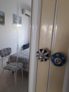 a room with a bed and a chair and a mirror at Casa in SALENTO a Otranto in Otranto