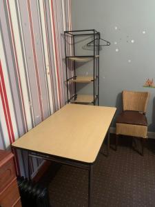 a desk in a room with a chair and a shelf at Budget house with wifi and parking close to amenities in Burton upon Trent