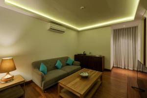 uma sala de estar com um sofá e uma mesa em Aprota Villas Arugambay em Arugam Bay