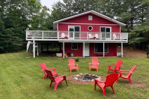 a group of red chairs in front of a red house at Apres Chalet in Carroll
