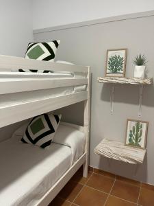 a bedroom with two bunk beds with plants on them at Casa rural La Alcaparra in Écija