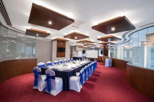 a conference room with a long table with blue bows at City Premiere Hotel Apartments - Dubai in Dubai +37 photos