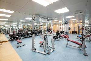 a gym with several rows of treadmills and machines at City Premiere Hotel Apartments - Dubai in Dubai