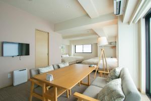 a living room with a table and a couch at Minn Higashi-Ueno in Tokyo