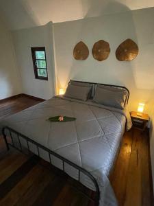 a bedroom with a large bed with two mirrors on the wall at Vanara Bungalows in Ko Chang