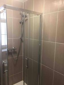 a shower with a glass door in a bathroom at APlaceToStay Central London apartment, Zone 1 BAK in London