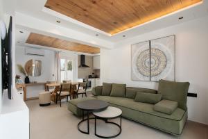 a living room with a couch and a table at Amelia villas Naxos in Naxos Chora