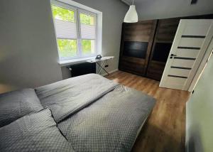Posteľ alebo postele v izbe v ubytovaní Apartament Majka