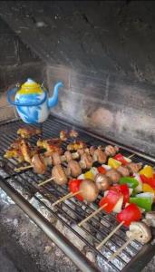 a grill with vegetables and a teapot on it at Deluxe Villa Coast River Sarajevo in Visoko