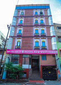 a building with a sign on the front of it at Hotel New West Tower in Madurai