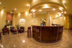 a large lobby with a reception counter and chairs at Hotel Alinalex - Paradisul Acvatic in Braşov