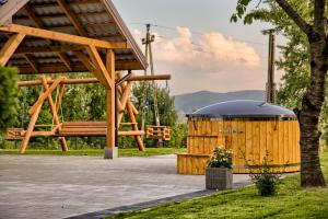 einen hölzernen Pavillon und eine Holzbank in der Unterkunft Zielone Wzgórze in Posadowa
