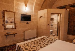 a bedroom with a bed and a sink in a room at Larissa Cave Hotel in Nevşehir +163 photos