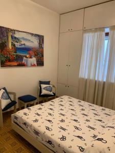 1 dormitorio con 1 cama y una pintura en la pared en Arco Apartment - Vietri sul Mare, en Vietri