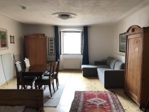 a living room with a couch and a table at Blick aufs Goldene Dachl in Innsbruck
