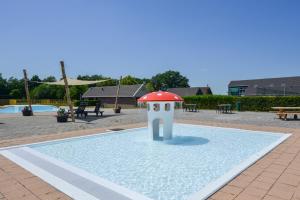 a small bird house sitting in a pool of water at Park Drentheland in Zorgvlied