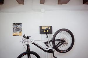 a bike is hanging on a wall at Fonda Can Fasersia in Pobla de Segur