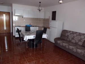 a living room with a table and chairs and a couch at Secluded fisherman's cottage Cove Dragisina, Kornati - 12150 in Pristanišće