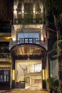 a building with an archway in a city at night at Apartments by Vitrine in Hanoi