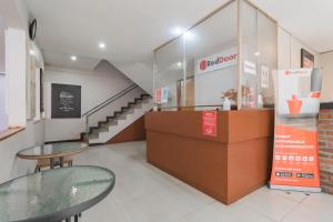 a store with two glass tables and a staircase at RedDoorz Plus @ Dago Pojok 3 in Bandung