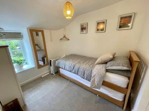 a bedroom with a bed and a window at 3 Peters Terrace in Truro