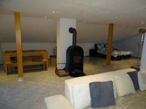 a living room with a couch and a wood stove at Ferienwohnung Waldweg in Grafenwiesen