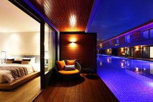 a bedroom with a bed and a swimming pool at AKIRA Lipe Resort in Ko Lipe