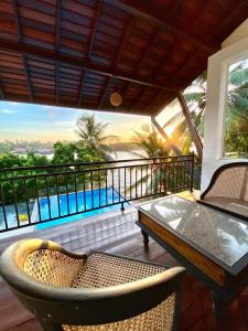 a patio with a table and chairs on a balcony at Hotel Nilwala in Bentota