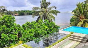 an ocean view of a villa with a swimming pool at Hotel Nilwala in Bentota