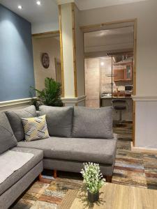 a living room with a couch and a kitchen at Alexander House in Alexandria
