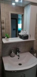 a bathroom with a sink and a mirror at Krstić_lux apartman in Subotica +36 photos