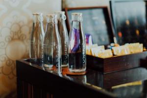 a group of glass bottles sitting on a table at The Fullerton Bay Hotel Singapore in Singapore