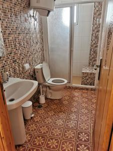 a bathroom with a toilet and a sink and a shower at Maison d'Hôtes Casa Azla in Azla