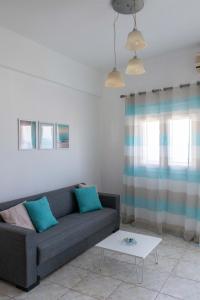 a living room with a couch and a table at Lovely sea view apartment at the heart of the town in Ierápetra