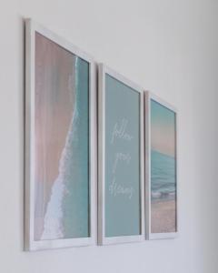 three pictures of the beach on a wall at Lovely sea view apartment at the heart of the town in Ierápetra