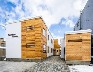 a building with wooden panels on the side of it at Terrace Toyohira / Vacation STAY 81232 in Sapporo