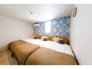 two beds in a small room with at Terrace Toyohira / Vacation STAY 80868 in Sapporo