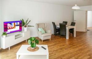 a living room with a tv and a table and chairs at 1 Bedroom Beautiful Apartment In Passow Ot Charlottenho in Zahren