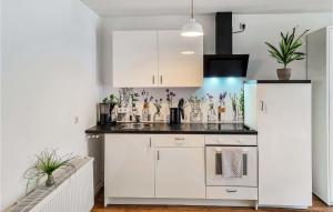 a kitchen with white cabinets and a refrigerator at 1 Bedroom Beautiful Apartment In Passow Ot Charlottenho in Zahren
