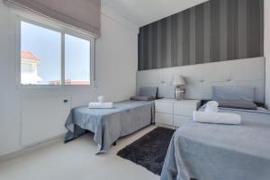 a white room with two beds and a window at Doris 2 in Gandía