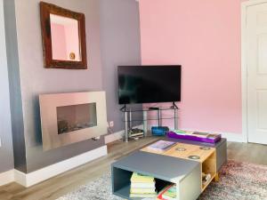 a living room with a tv and a coffee table at Almarie in Fort William