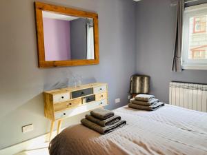 a bedroom with a bed with a dresser and a mirror at Almarie in Fort William