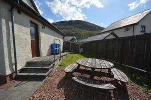 a picnic table in a yard next to a building at Gallunach House in Fort William