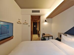 Postel nebo postele na pokoji v ubytování Prince Smart Inn Kyoto Shijo Omiya