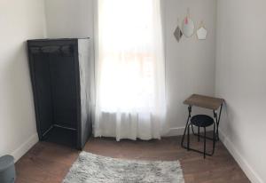 a bathroom with a shower and a table and a window at Blue house in Lincoln