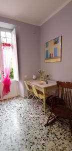 um quarto com uma mesa, uma cadeira e uma janela em Il Giardino di Maura - Aemme2 em Recanati