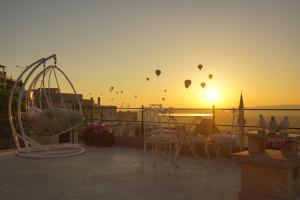 a group of hot air balloons in the sky at sunset at Karlık Cave Suite Cappadocia in Uchisar